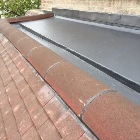 New flat roof with a lead-dressed edge and tiled verge, fitted by Tresan Roofing
