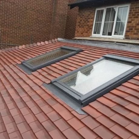 Two Velux roof windows fitted into a clay tile roof by Tresan Roofing, Surrey
